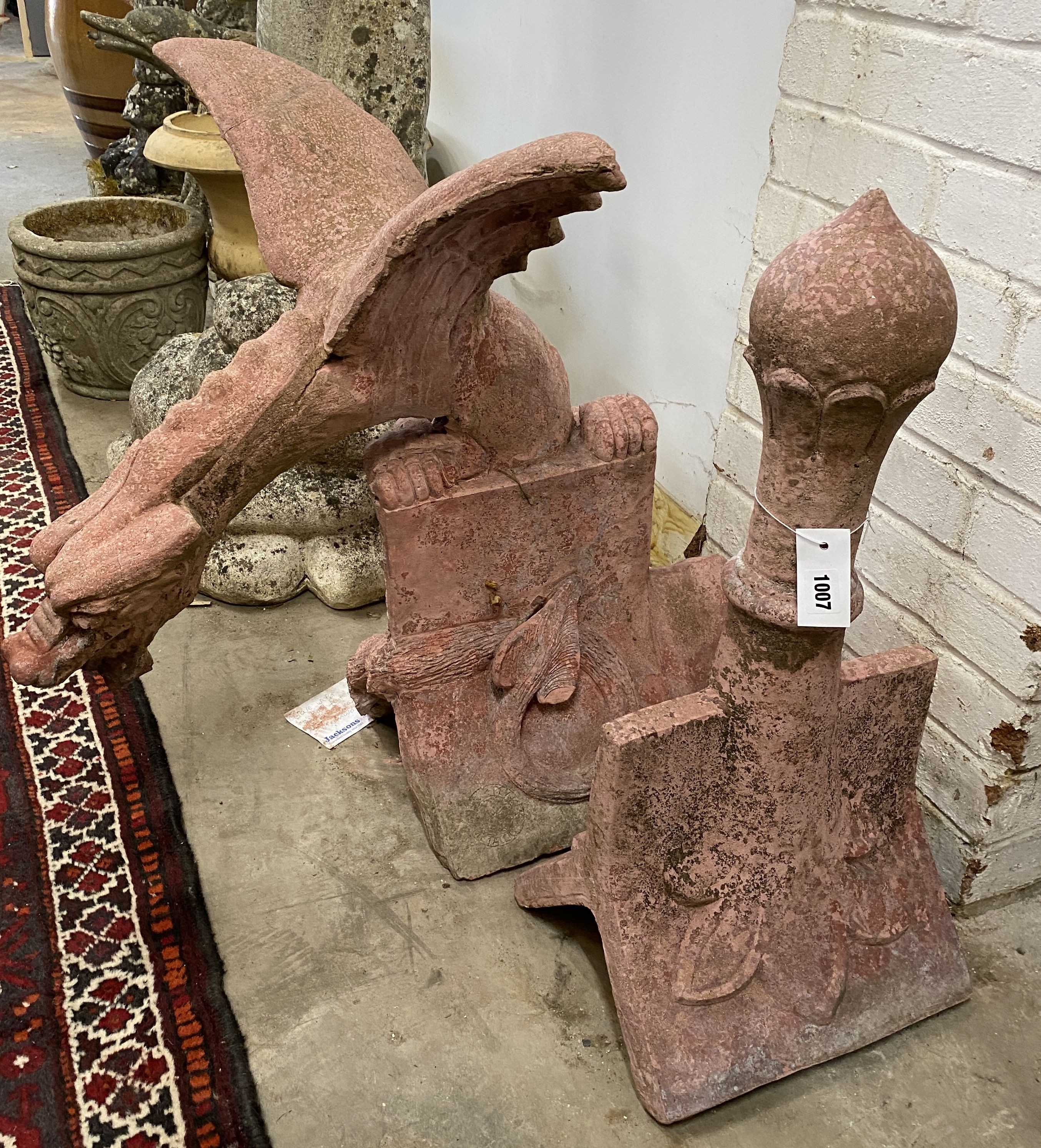 A painted reconstituted stone gargoyle hip tile together with a ball finial hip tile, largest height 69cm